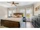 Main bedroom with a wooden bed frame, ceiling fan, and two windows with sheer curtains at 1816 E 15Th Ave, Tampa, FL 33605
