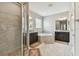Bright bathroom featuring a tub, walk-in shower, double vanity, and tile flooring at 19316 Eagle Creek Ln, Tampa, FL 33647