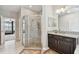 Bathroom showcasing a walk-in shower, granite vanity, and neutral tile flooring at 19316 Eagle Creek Ln, Tampa, FL 33647
