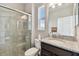 Bathroom featuring a walk-in shower with glass door, granite vanity, and toilet at 19316 Eagle Creek Ln, Tampa, FL 33647