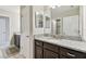 Bathroom features a granite vanity with a mirror and dark cabinets at 19316 Eagle Creek Ln, Tampa, FL 33647