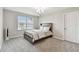 Bedroom with gray walls, carpet, and a large window providing lots of natural light at 19316 Eagle Creek Ln, Tampa, FL 33647