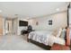 Bright bedroom featuring a large bed, a workspace, and neutral wall colors at 19316 Eagle Creek Ln, Tampa, FL 33647