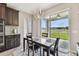 Bright dining area with dark wood cabinets, modern lighting, and a sliding glass door to the backyard at 19316 Eagle Creek Ln, Tampa, FL 33647