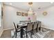 Elegant dining room featuring a dark wood table, cushioned chairs, decorative rug, and a stunning chandelier at 19316 Eagle Creek Ln, Tampa, FL 33647