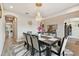 The dining room features an elegant chandelier, a dark wood table with gray chairs, and wood-look tile flooring at 19316 Eagle Creek Ln, Tampa, FL 33647