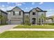 Elegant two-story home featuring stone accents, a well-maintained lawn, and a two-car garage at 19316 Eagle Creek Ln, Tampa, FL 33647