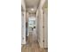 Hallway with wood-look flooring leading to the kitchen and other rooms at 19316 Eagle Creek Ln, Tampa, FL 33647