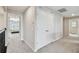 Hallway features a double-door closet, neutral paint, and carpet flooring leading to the bedroom with natural light at 19316 Eagle Creek Ln, Tampa, FL 33647