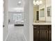 Hallway leads to a bedroom with neutral walls and natural light to the left and a bathroom to the right at 19316 Eagle Creek Ln, Tampa, FL 33647