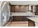 Well-lit kitchen showing stainless steel appliances, tile backsplash, and ample dark wood cabinetry at 19316 Eagle Creek Ln, Tampa, FL 33647