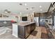 Open-concept kitchen featuring granite countertops, a kitchen island with a sink, and stainless steel appliances at 19316 Eagle Creek Ln, Tampa, FL 33647