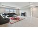 Spacious living room with a black sectional sofa, large windows, and neutral decor at 19316 Eagle Creek Ln, Tampa, FL 33647
