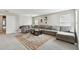 Spacious living room boasts a large gray sectional, neutral walls, natural light, and a decorative area rug at 19316 Eagle Creek Ln, Tampa, FL 33647