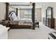 The main bedroom features a decorative four-poster bed, sitting area, and ornate wood furniture at 19316 Eagle Creek Ln, Tampa, FL 33647