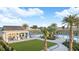 Inviting community pool and clubhouse, complete with a cozy outdoor seating area and lush landscaping at 2204 Paravane Way, Wesley Chapel, FL 33543