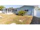 Large backyard featuring a screened-in patio, white fence, and room to roam at 22465 Lewiston Ave, Port Charlotte, FL 33952