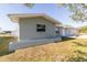 Angle view of the exterior showing a clean yard with plants at 22465 Lewiston Ave, Port Charlotte, FL 33952