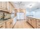 Spacious kitchen with wooden cabinets, granite countertops, and white appliances at 22465 Lewiston Ave, Port Charlotte, FL 33952