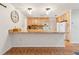 Open kitchen featuring wooden cabinets, granite countertops, and modern lighting at 22465 Lewiston Ave, Port Charlotte, FL 33952
