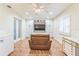 Cozy living room with custom cabinets, recessed lighting, light fan, shutters, and a leather chair at 22465 Lewiston Ave, Port Charlotte, FL 33952