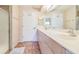 Bright bathroom boasts a double vanity and a glass-enclosed shower at 22465 Lewiston Ave, Port Charlotte, FL 33952