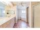 Bright bathroom boasts a double vanity, a separate bathtub, and a glass-enclosed shower at 22465 Lewiston Ave, Port Charlotte, FL 33952