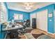 A spacious office features a large desk, a window, ample storage and a ceiling fan at 22465 Lewiston Ave, Port Charlotte, FL 33952
