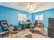 Bright home office features a large window with shuttered blinds, a ceiling fan, and two chairs at 22465 Lewiston Ave, Port Charlotte, FL 33952