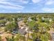 Scenic aerial shot of a charming neighborhood with tree-lined streets and a home featuring modern solar panels for energy efficiency at 2394 19Th Sw Ave, Largo, FL 33774