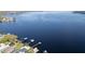Expansive aerial view of a serene lake, showcasing docks and boathouses along the shoreline at 250 W Canal Dr, Palm Harbor, FL 34684