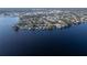 An aerial view of a community of waterfront homes with docks along a picturesque lake at 250 W Canal Dr, Palm Harbor, FL 34684