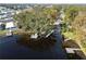 Aerial view of docks and waterfront properties showcasing the serene lake and surrounding landscape at 250 W Canal Dr, Palm Harbor, FL 34684