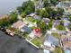 Aerial view of a waterfront property with lush landscaping and canal access to a wide, open lake at 250 W Canal Dr, Palm Harbor, FL 34684
