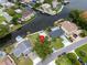 Aerial view of waterfront home with lush landscaping and canal access at 250 W Canal Dr, Palm Harbor, FL 34684