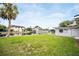 Spacious backyard featuring a canal view, lush lawn, and mature landscaping at 250 W Canal Dr, Palm Harbor, FL 34684