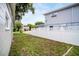 View of the side yard that has a white fence and grassy area at 250 W Canal Dr, Palm Harbor, FL 34684