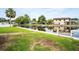 Backyard is green and opens onto canal with a view of the house at 250 W Canal Dr, Palm Harbor, FL 34684