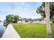 The backyard is green with a canal view and partial view of home at 250 W Canal Dr, Palm Harbor, FL 34684