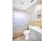 Bathroom featuring a shower with blue curtain, a toilet, and a vanity at 250 W Canal Dr, Palm Harbor, FL 34684
