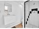 Bathroom with white tile shower with black accents, and small sink at 250 W Canal Dr, Palm Harbor, FL 34684