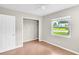 Neutral bedroom featuring an open closet and a large window at 250 W Canal Dr, Palm Harbor, FL 34684