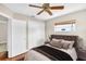 Cozy bedroom with hardwood floors, a comfortable queen-size bed, and a double door closet at 250 W Canal Dr, Palm Harbor, FL 34684