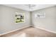 Neutral bedroom with tile flooring, a white ceiling fan, and sun-filled windows at 250 W Canal Dr, Palm Harbor, FL 34684
