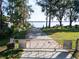 Community access point to the lake with a paved road and gate, offering serene waterfront views at 250 W Canal Dr, Palm Harbor, FL 34684