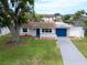 Charming single-story home featuring a well-maintained lawn, blue accents, and a classic white picket fence at 250 W Canal Dr, Palm Harbor, FL 34684