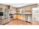 Well-lit kitchen with stainless steel appliances, granite countertops, and stylish cabinetry at 250 W Canal Dr, Palm Harbor, FL 34684
