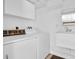 Bright laundry room featuring an utility sink and a washer and dryer at 250 W Canal Dr, Palm Harbor, FL 34684
