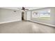 Open living room with tile flooring and large windows for natural light at 250 W Canal Dr, Palm Harbor, FL 34684