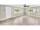 Living room with tile flooring, large windows, and views of the canal at 250 W Canal Dr, Palm Harbor, FL 34684